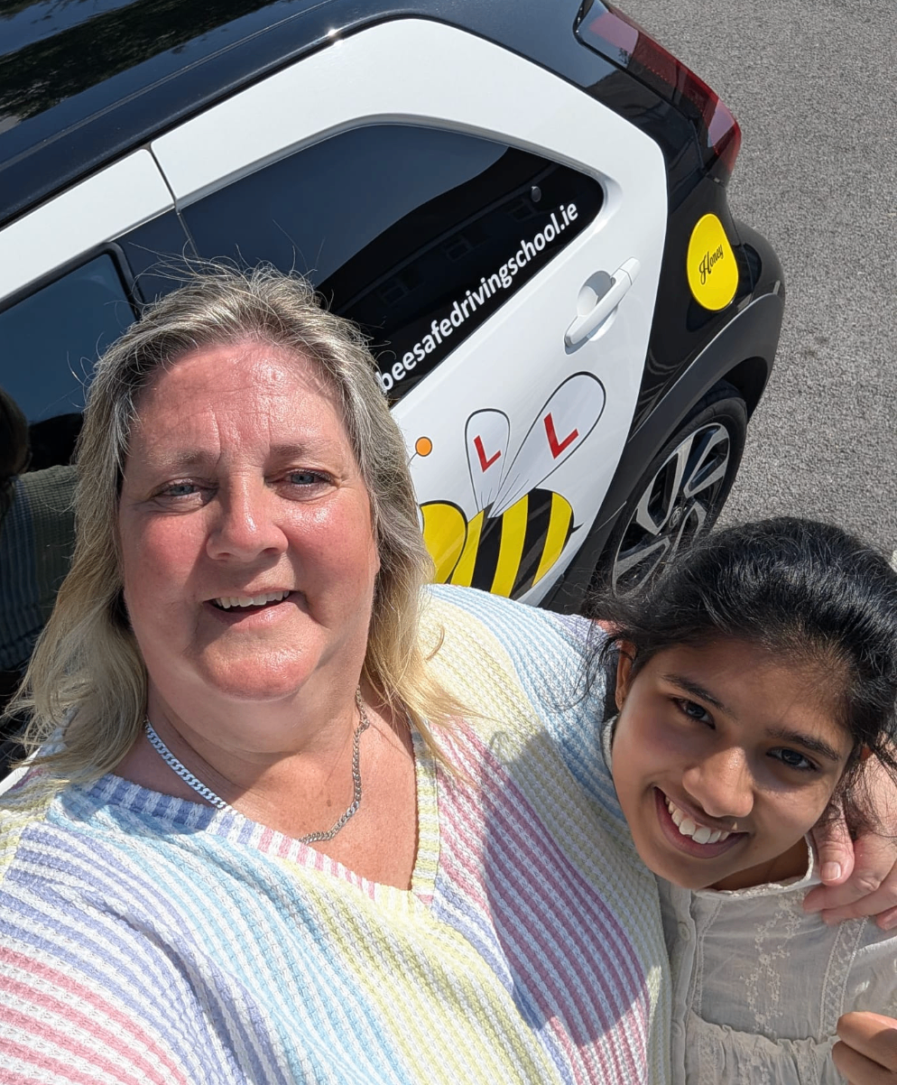 Bee Safe Driving School student celebrating beside the tuition car after passing in Roscommon